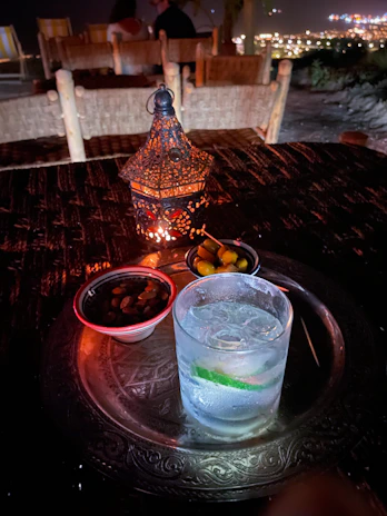 A lifestyle shot of the table used as a snack stand during a relaxed evening, with soft lighting and modern decor.