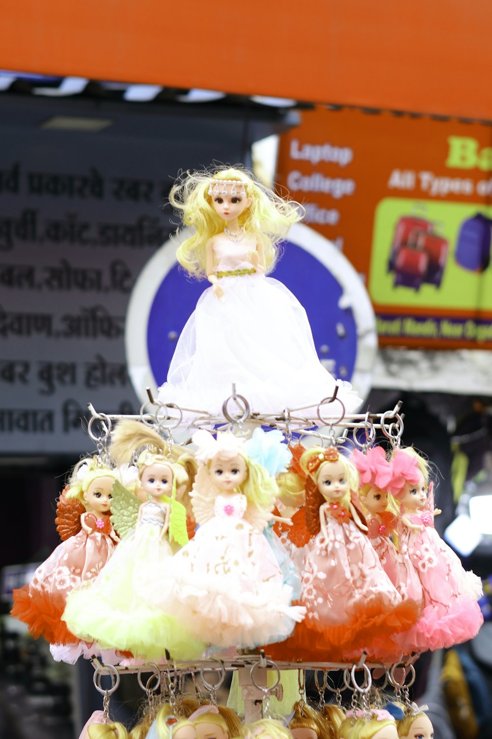 a person in a white dress with a group of dolls