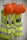 Several bright orange hard hats and fluorescent yellow safety vests with reflective strips are hanging on hooks on a wall.