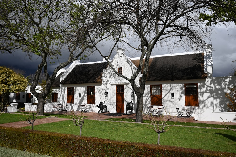 a white house with a lawn in front of it