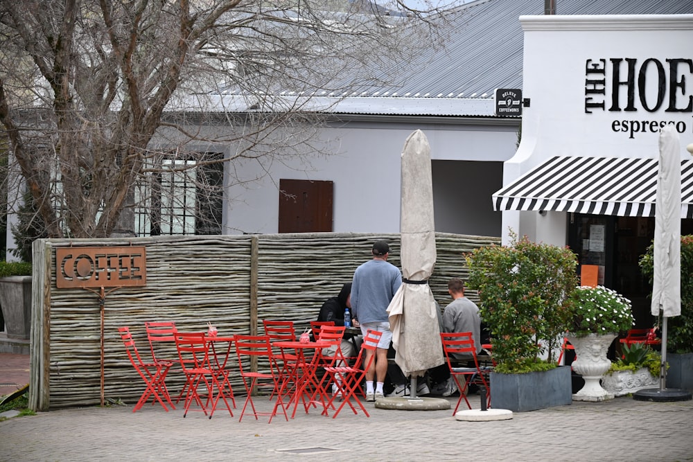 a couple of people standing outside a restaurant