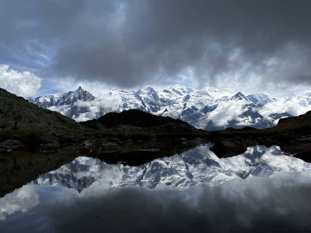 a body of water with mountains in the back