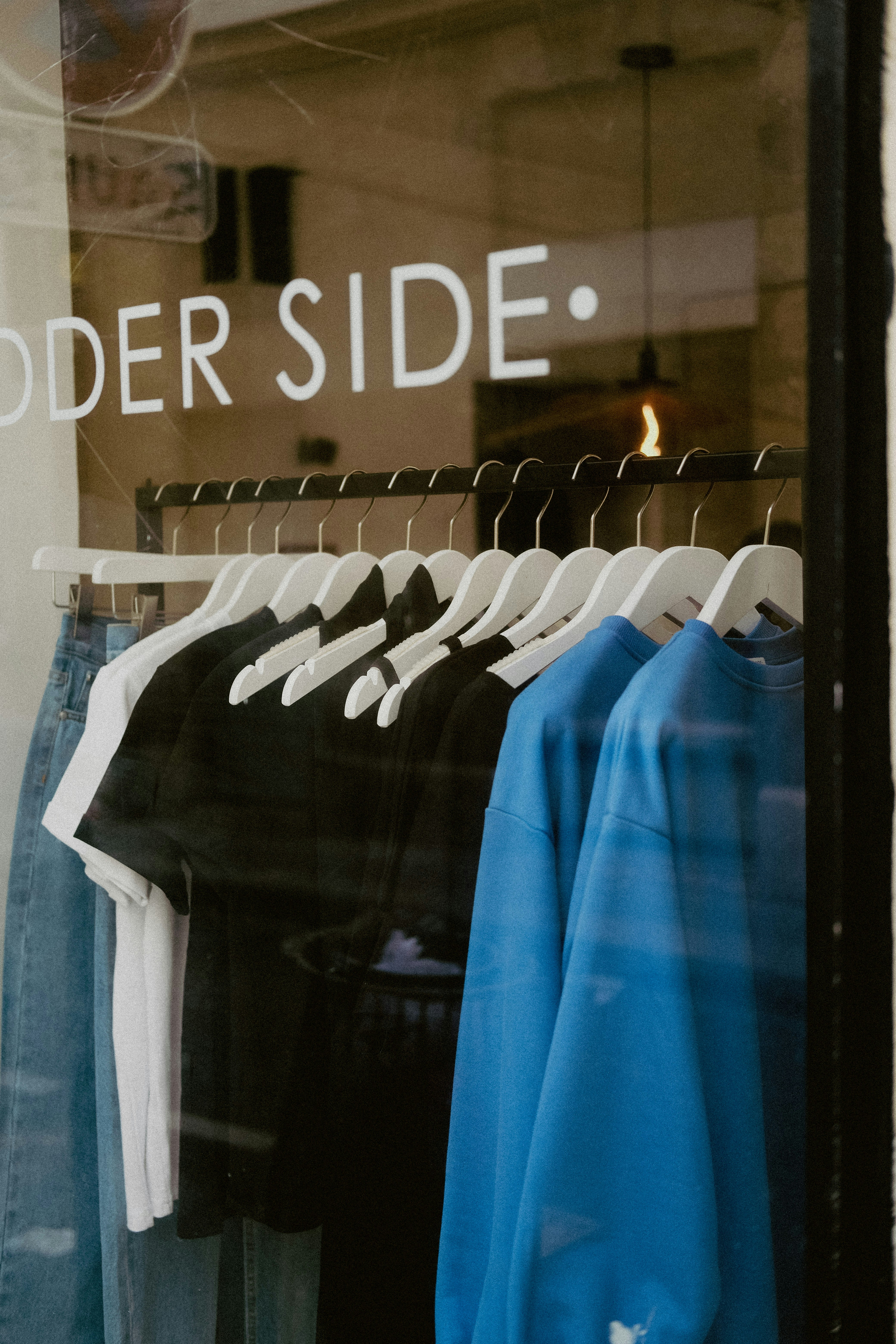 a store window with a group of shirts in it