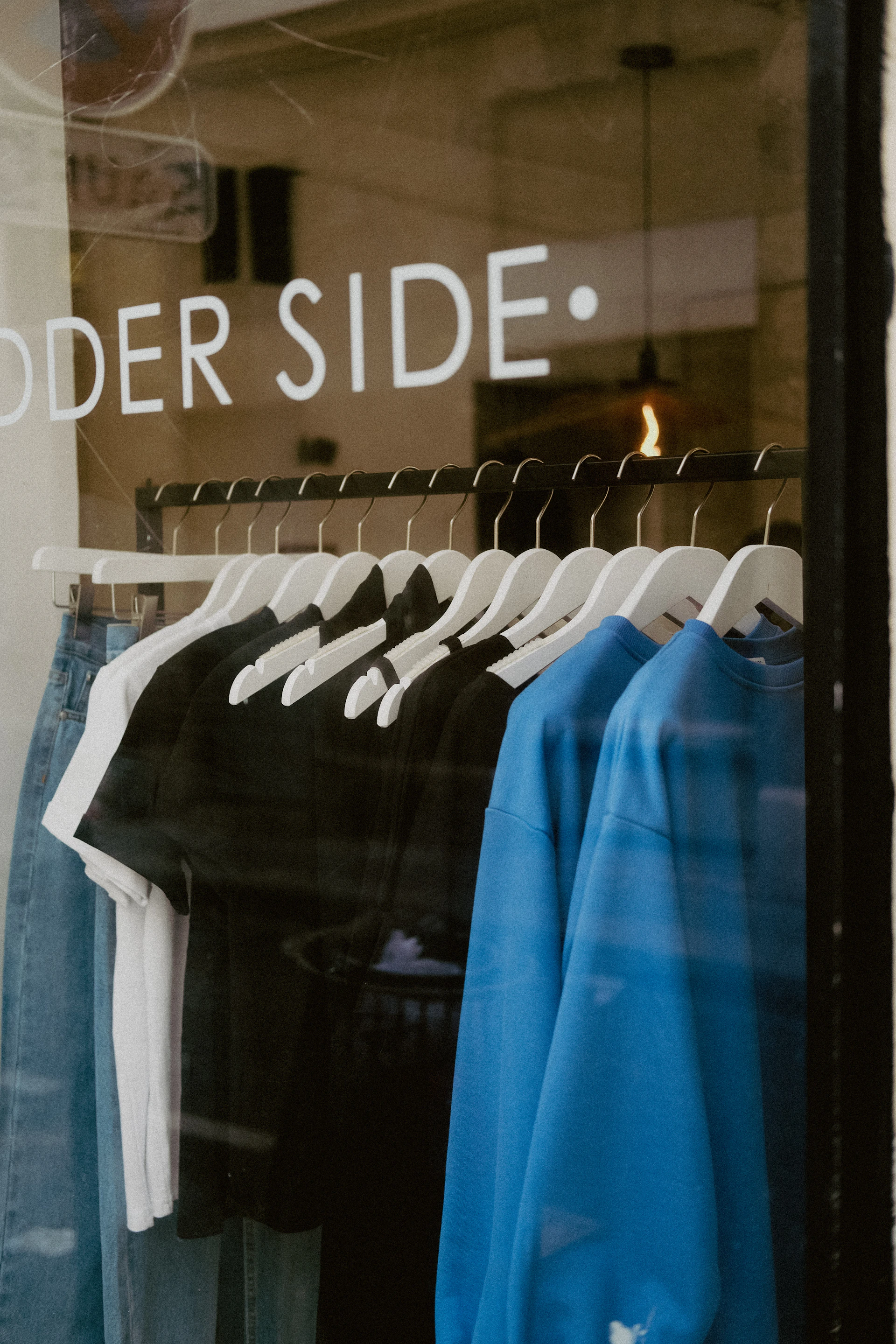 a store window with a group of shirts in it