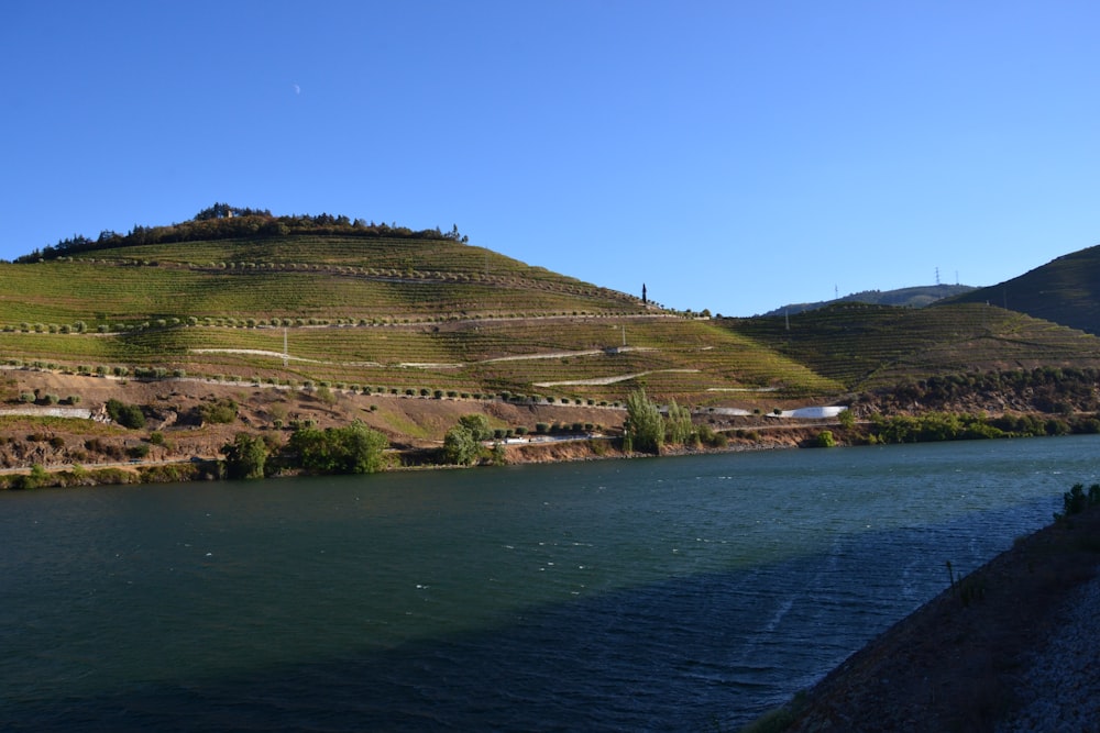 a body of water with hills in the background