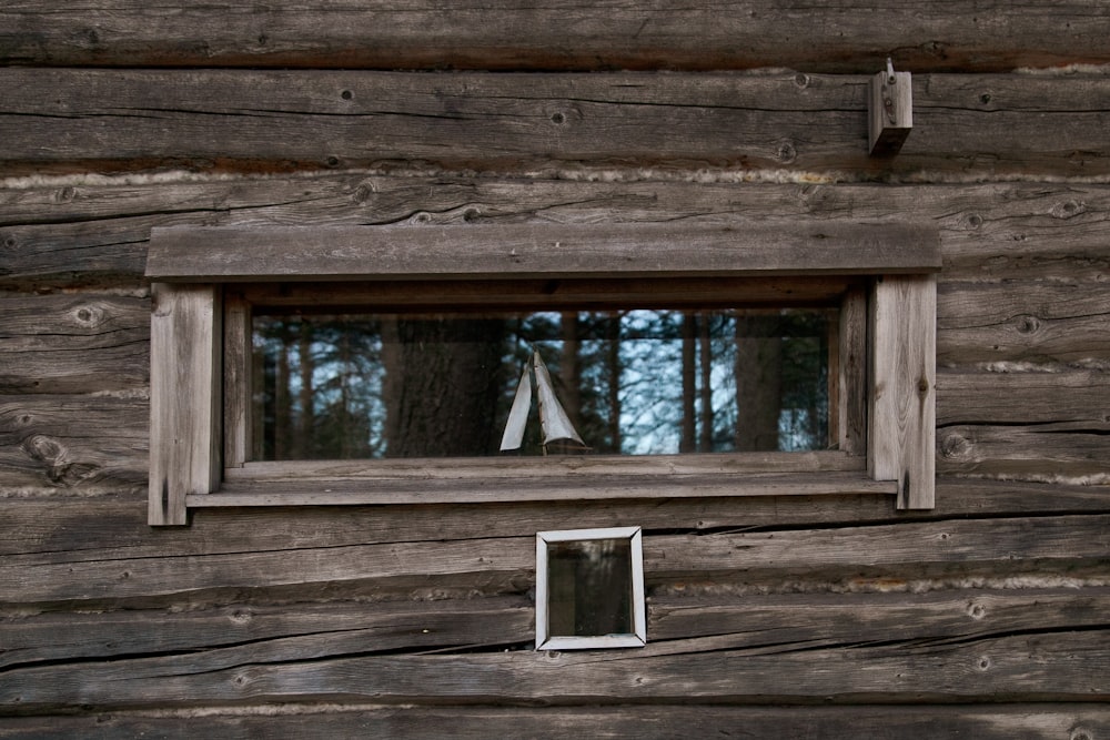 a wooden bench sitting next to a window