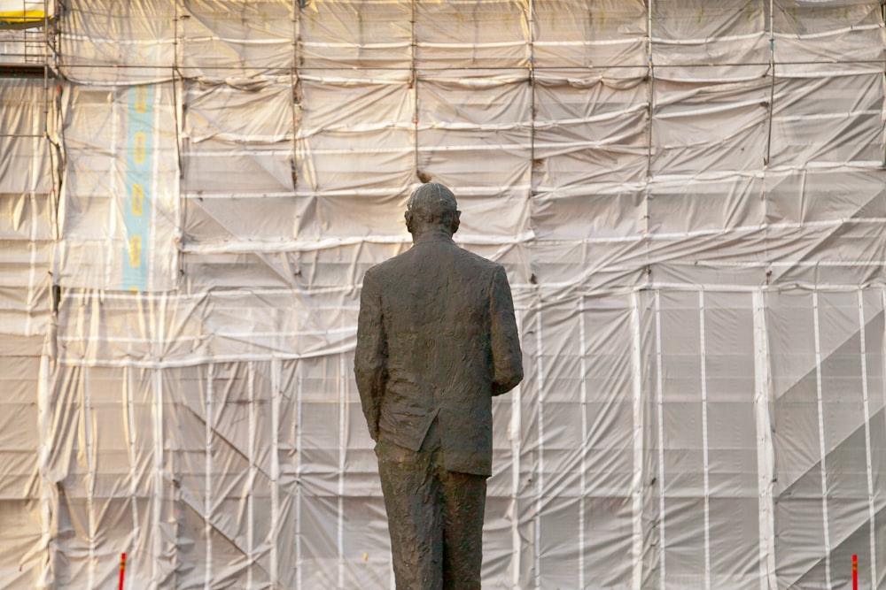 a man standing in front of a wall of white plastic