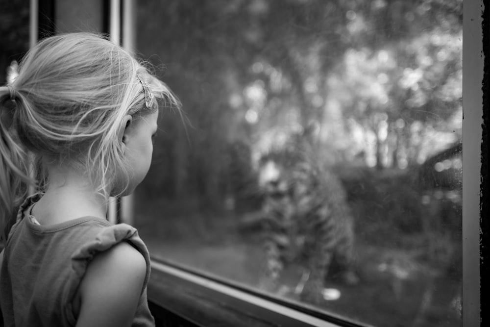 a little girl looking out a window