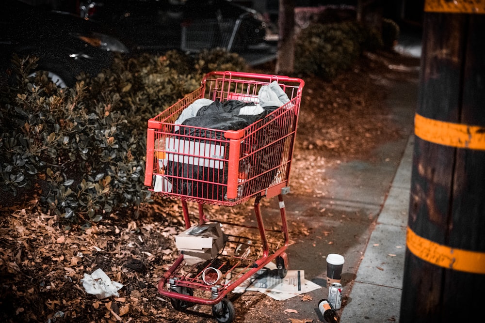 a shopping cart with a red shopping cart full of items