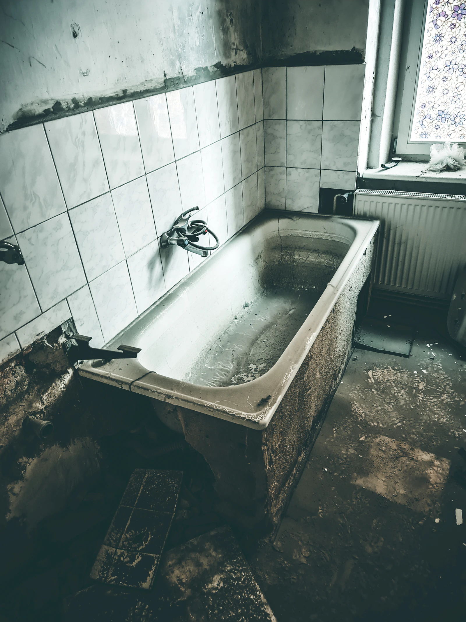 Grimy water-damaged bathroom before renovation