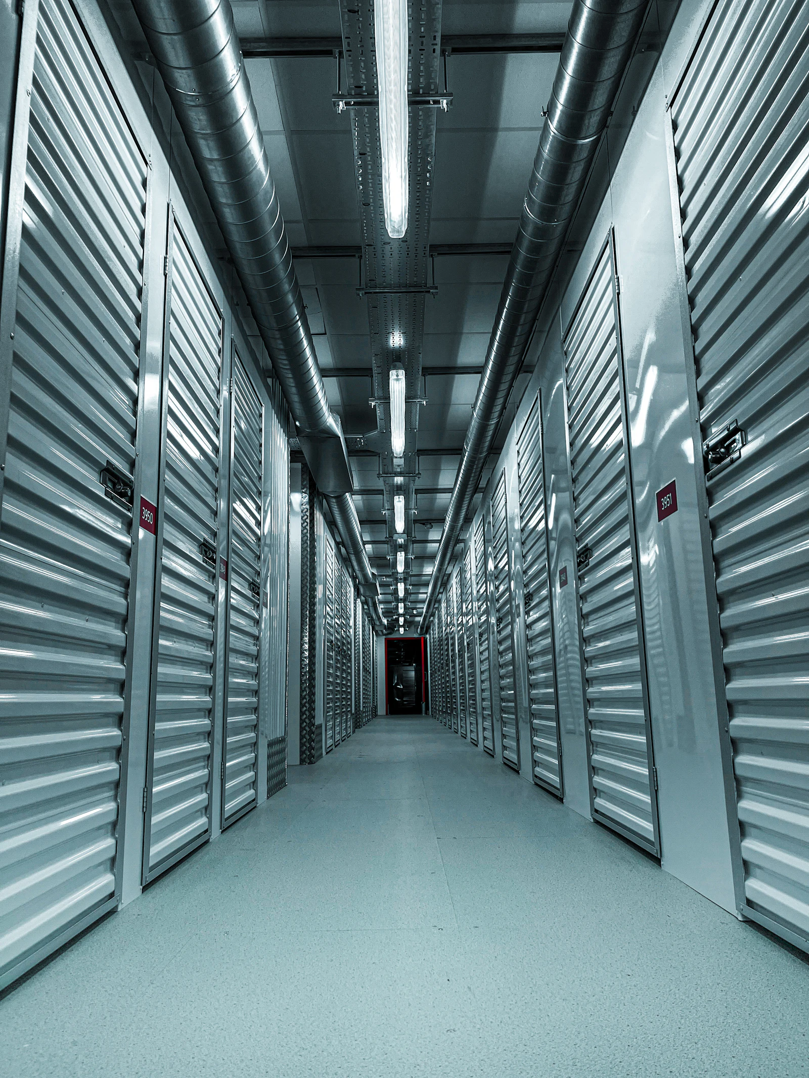 An indoor storage corridor lined with metal unit doors