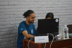 A close-up of a Vitalis team member reviewing medical articles on a laptop in a bright office.