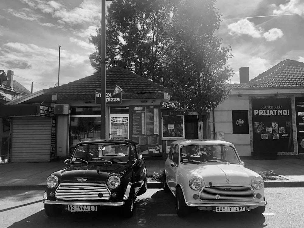 a couple of cars parked in front of a store