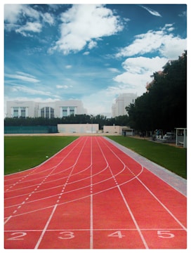 a track with a track and grass and buildings in the background