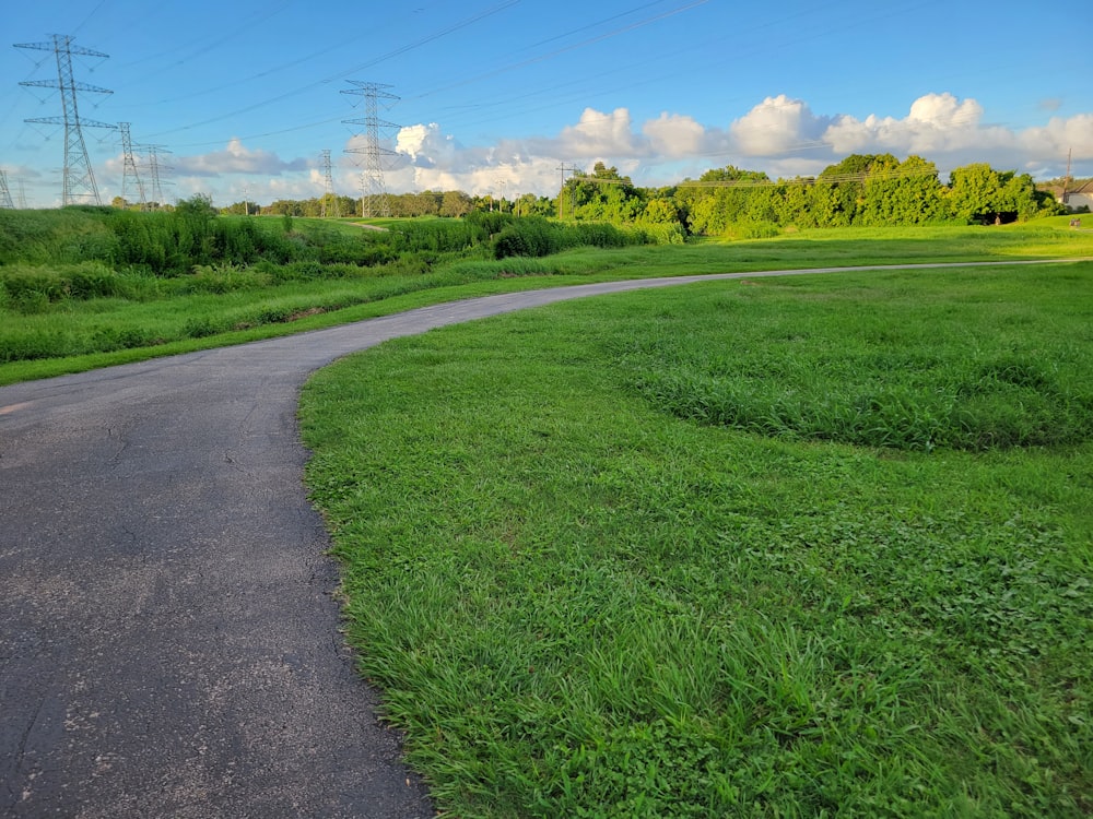 a road with grass and trees on the side