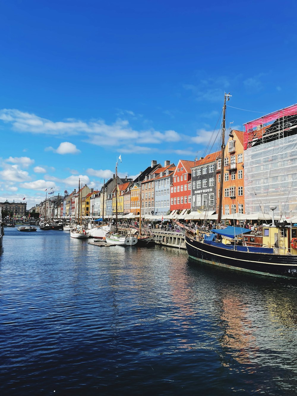 a body of water with boats in it and buildings around it