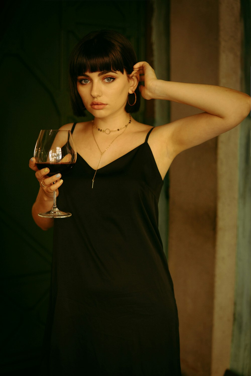 a woman holding a glass of wine