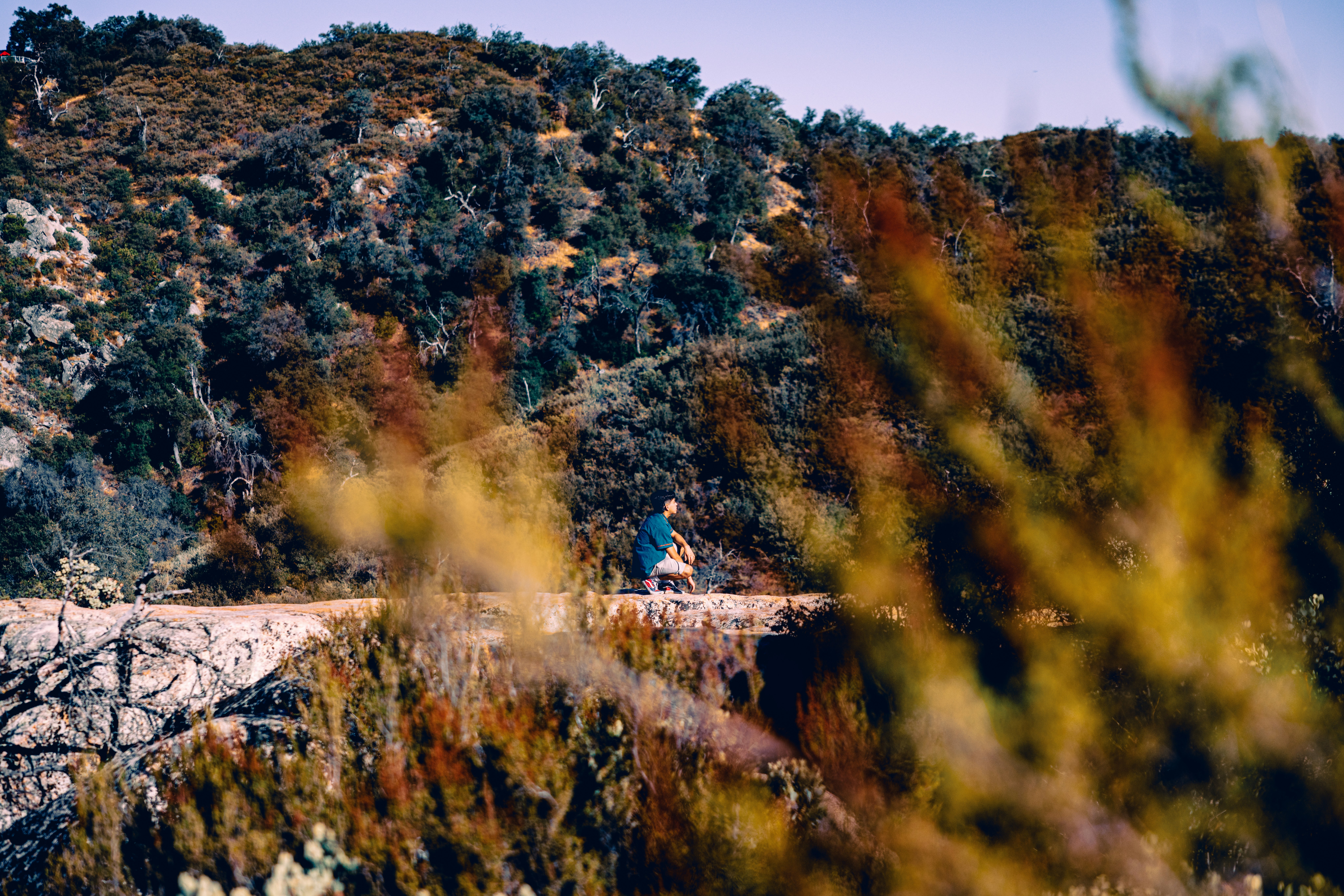 a person sitting on a rock