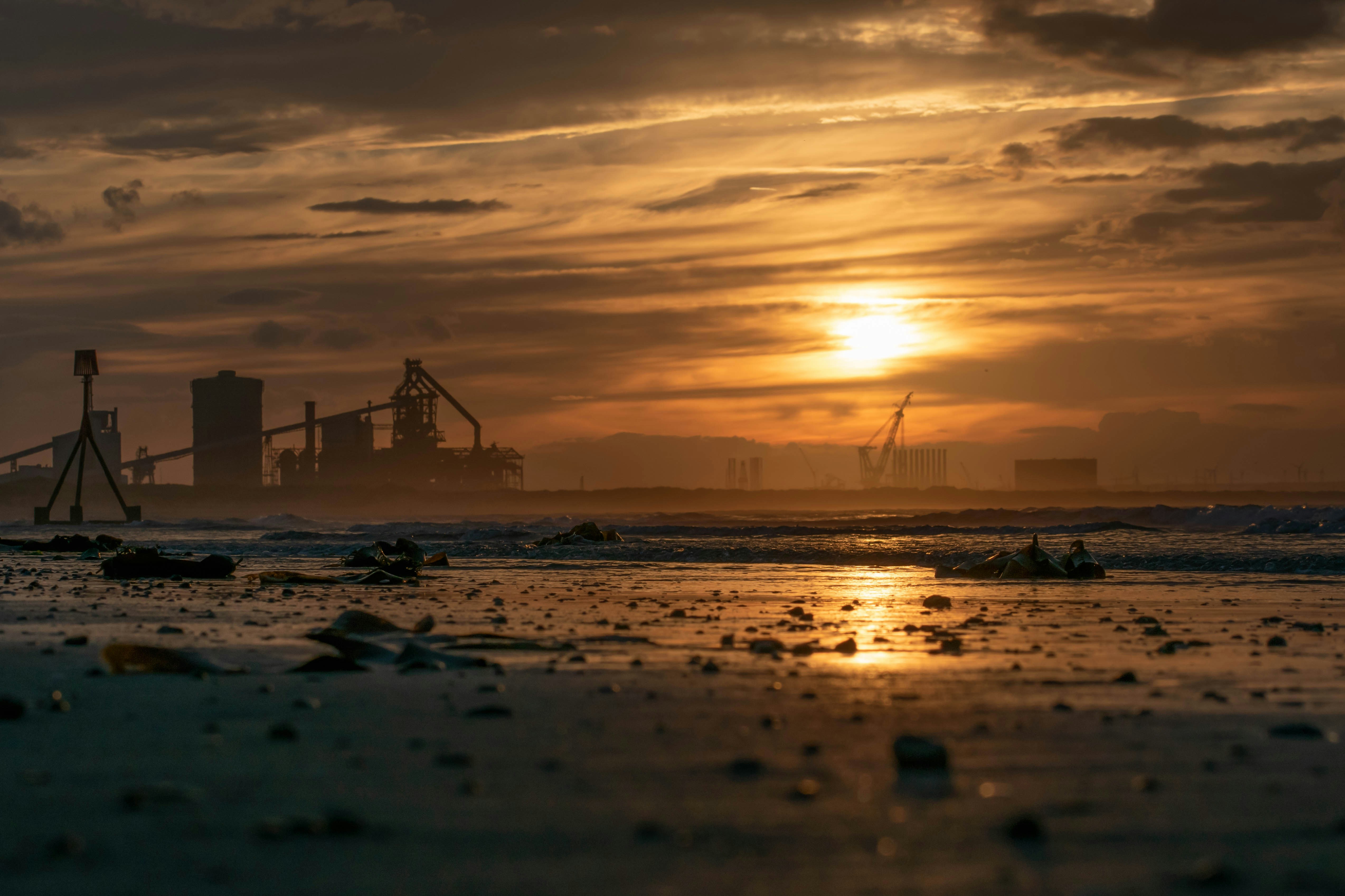 Aerial view of a factory with its roof covered in solar panels.