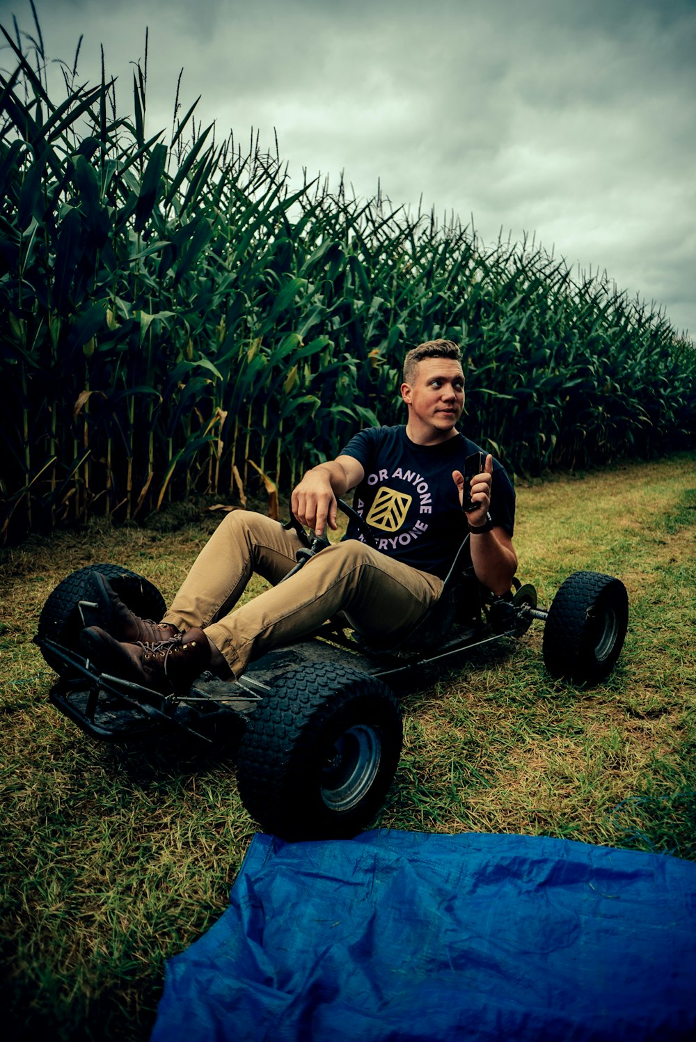 a person sitting on a lawnmower in a grassy area
