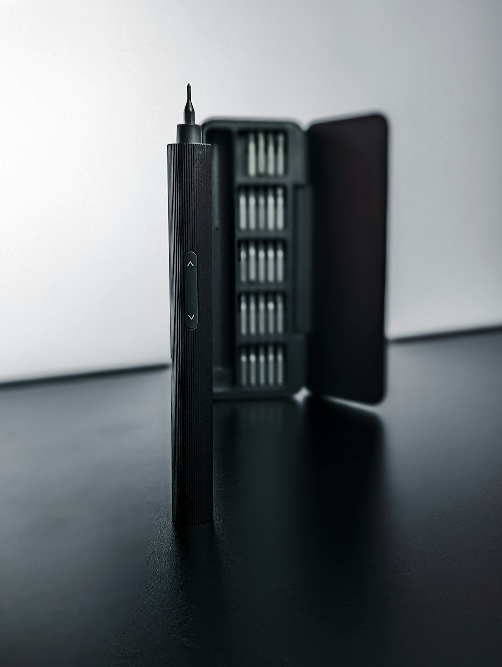 a black rectangular object with a metal tube on top