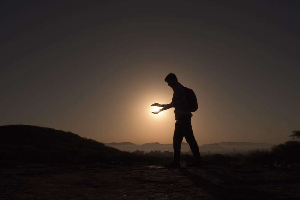 a man walking on a dirt road