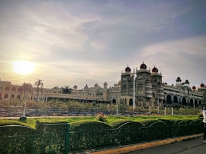 a large building with a bridge and a river in front of it