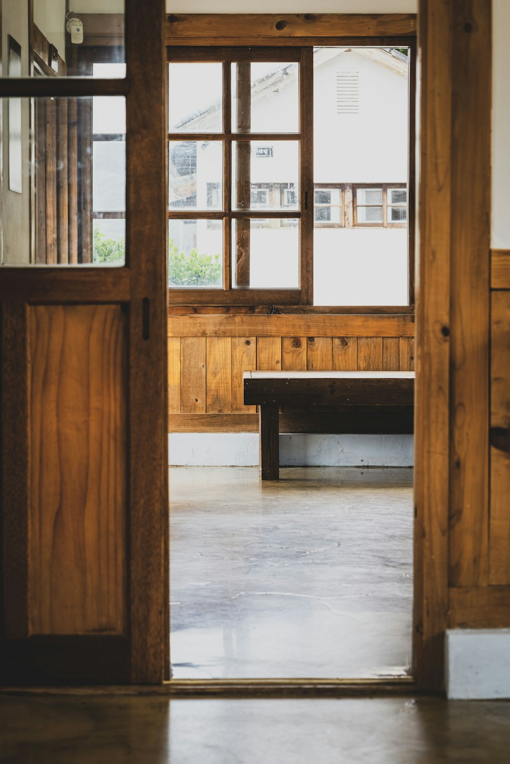 a room with a bench and a window