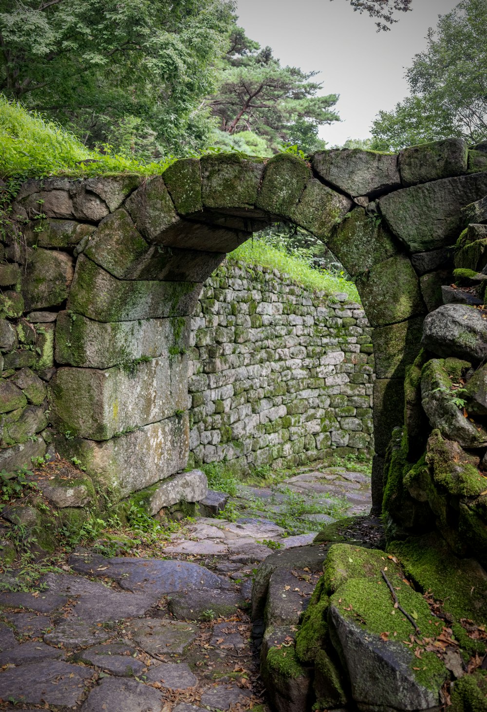 a stone wall with a stone arch