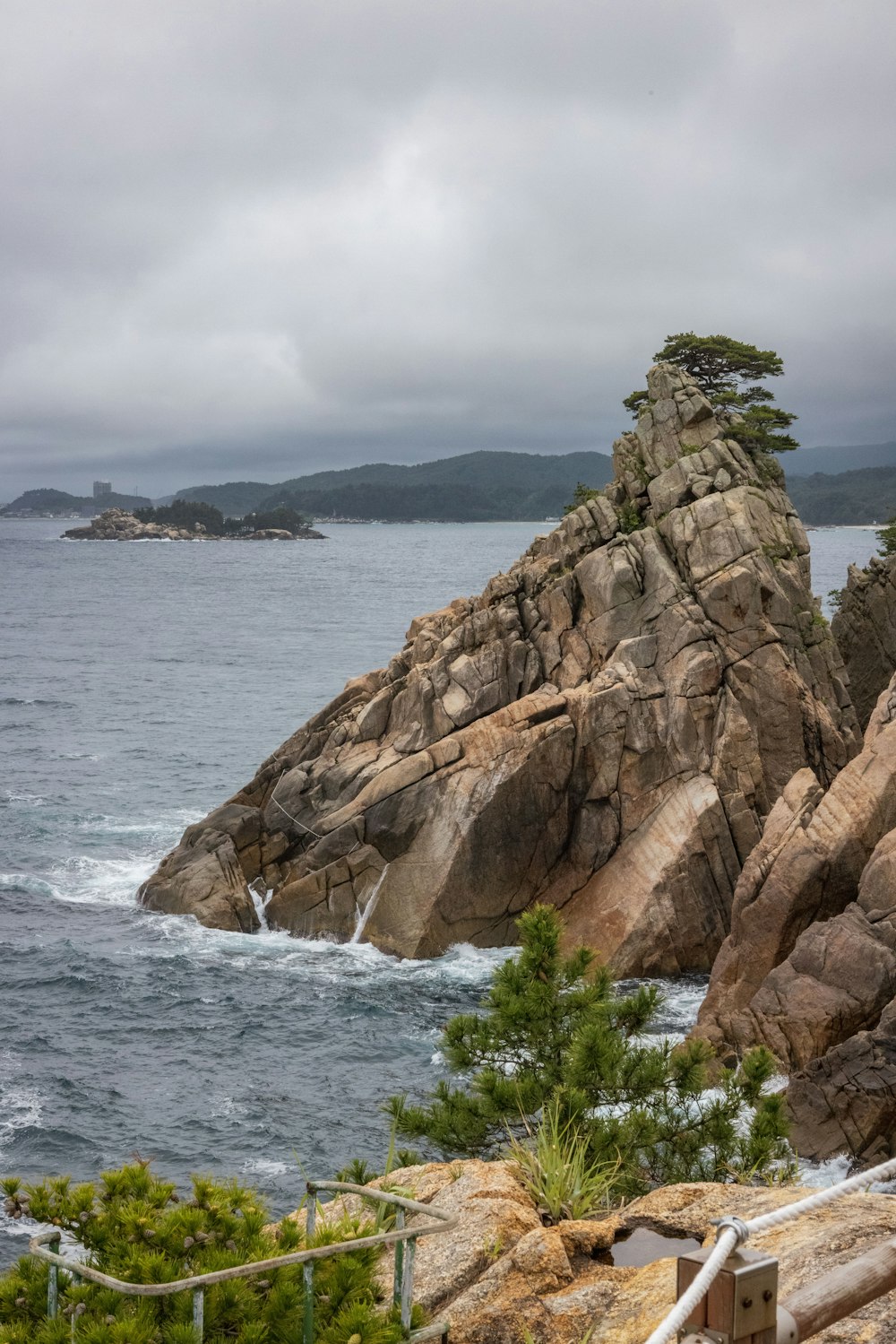 a rocky cliff next to a body of water