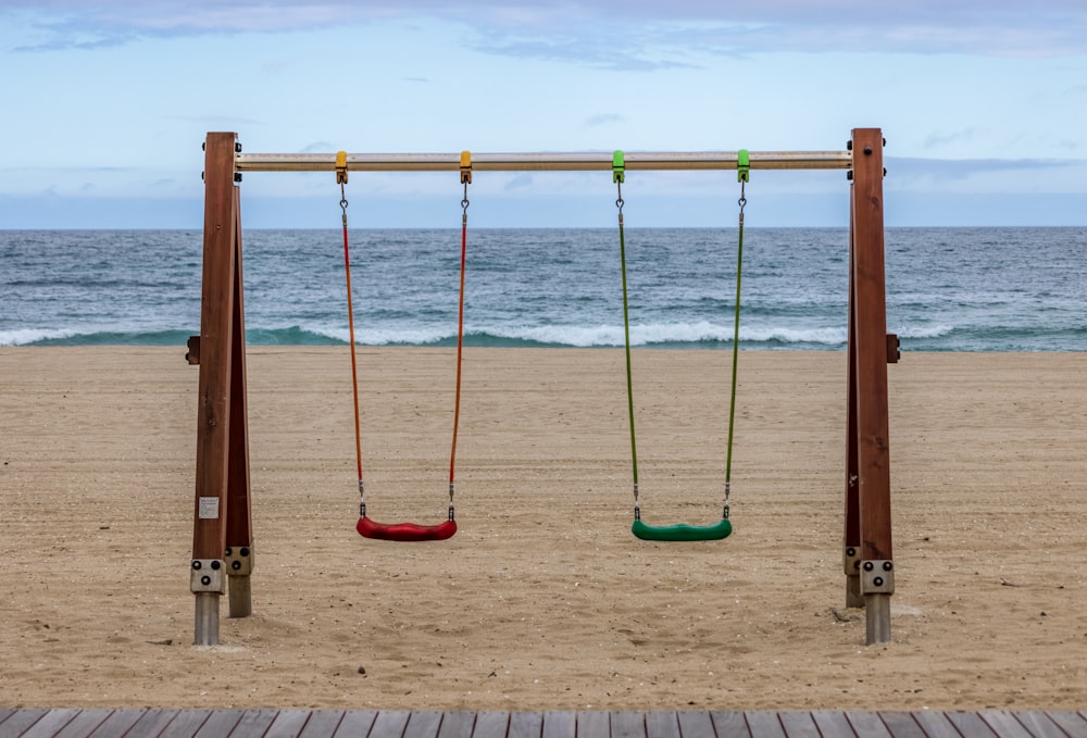 a row of swing sets on a beach