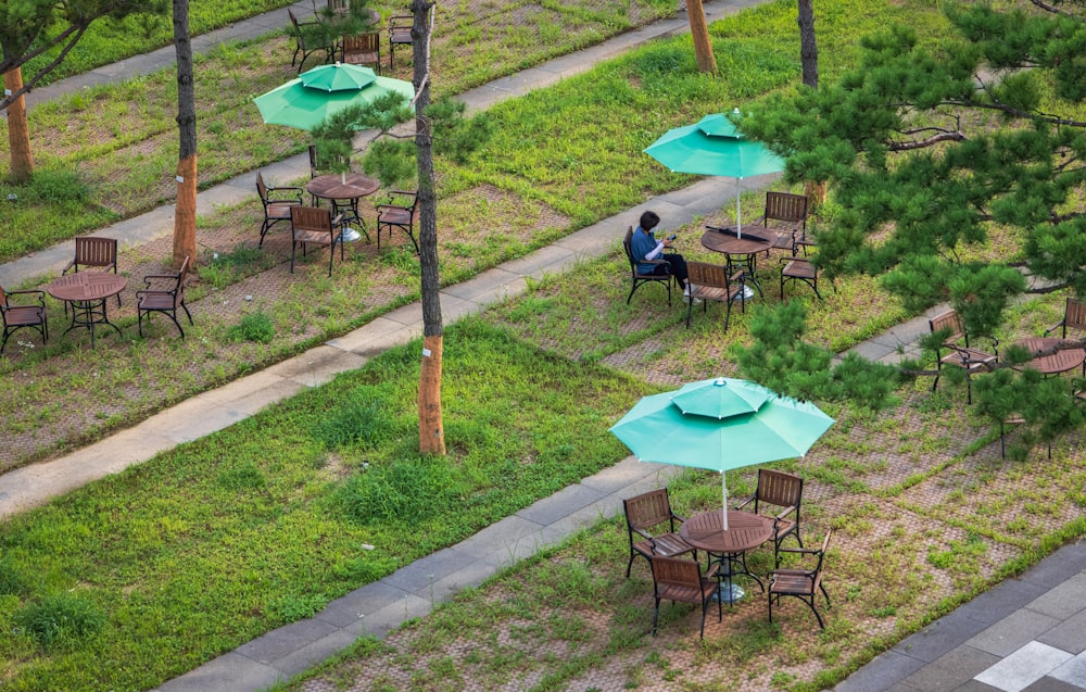 a person sitting at a table outside
