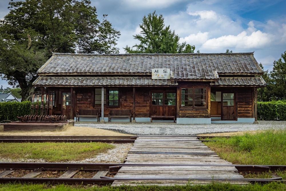 a wooden building with a train track