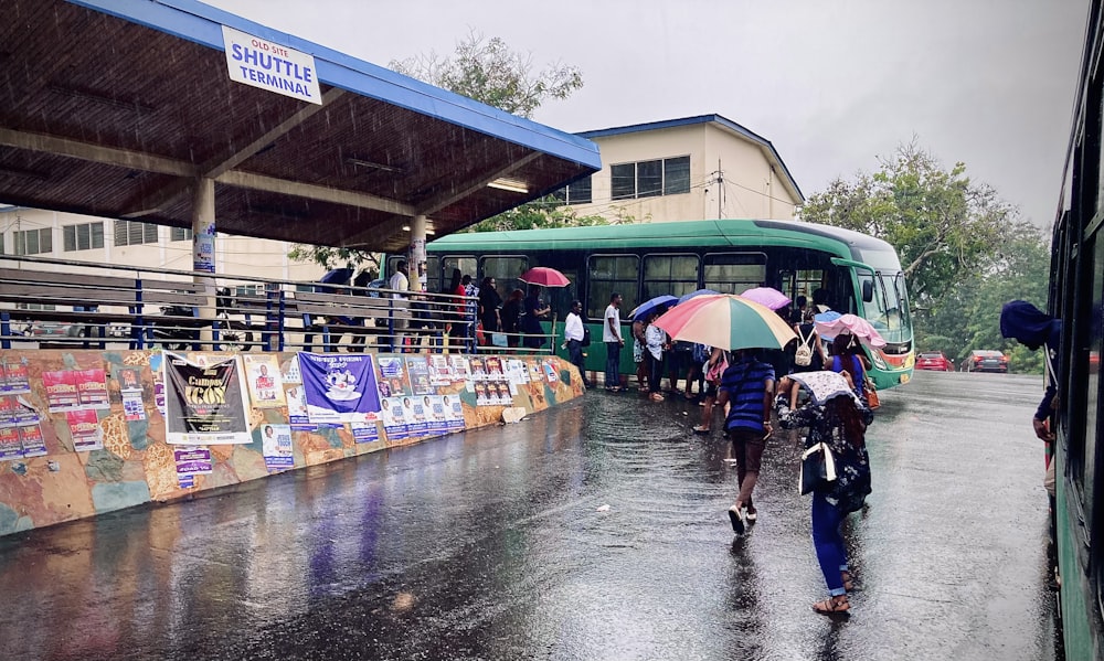 people walking in rain with umbrellas