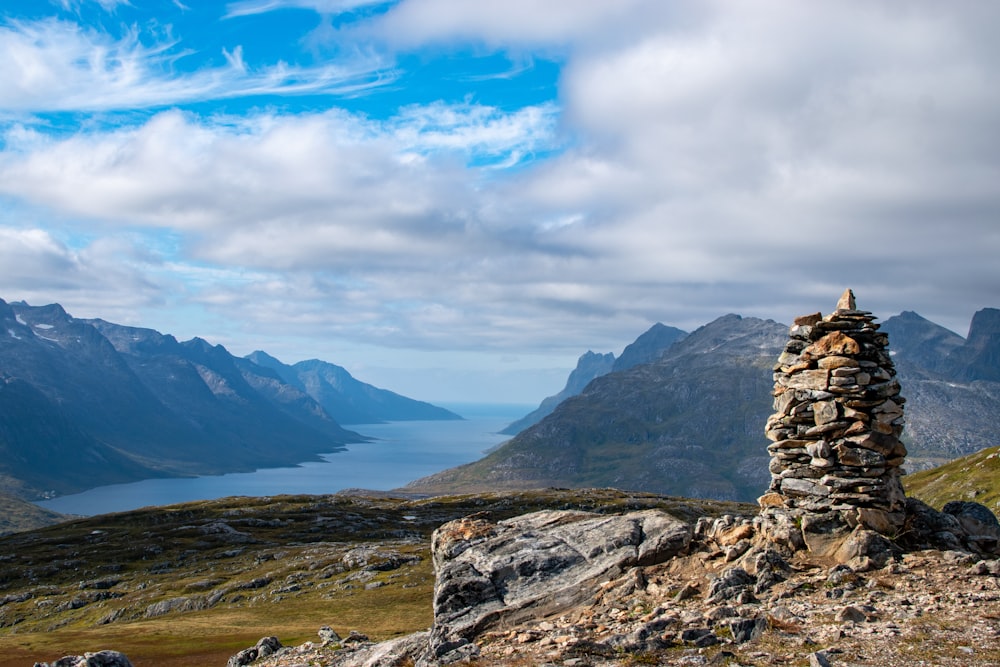 a rocky mountain with a lake in the background