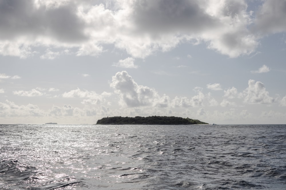 a large body of water with a small island in it