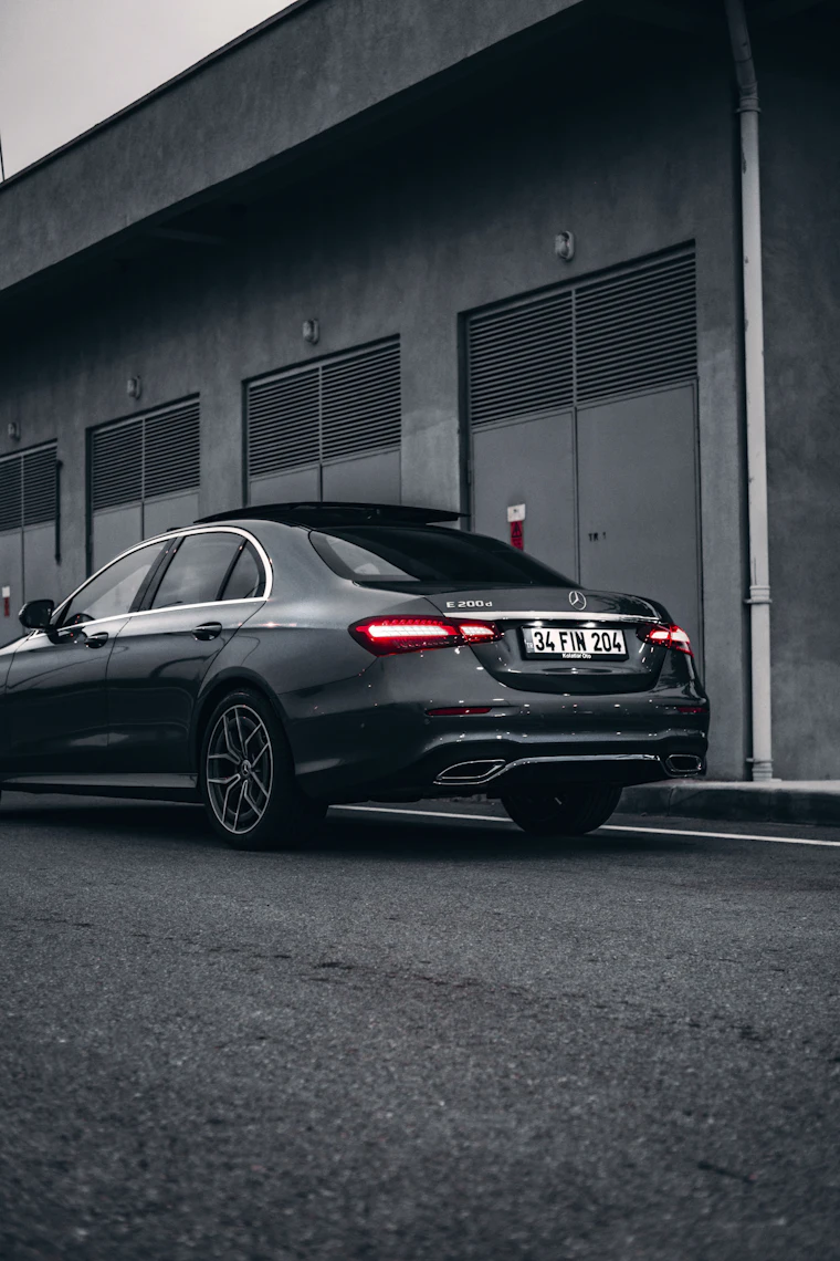 Black Mercedes E-Class saloon parked outside a building