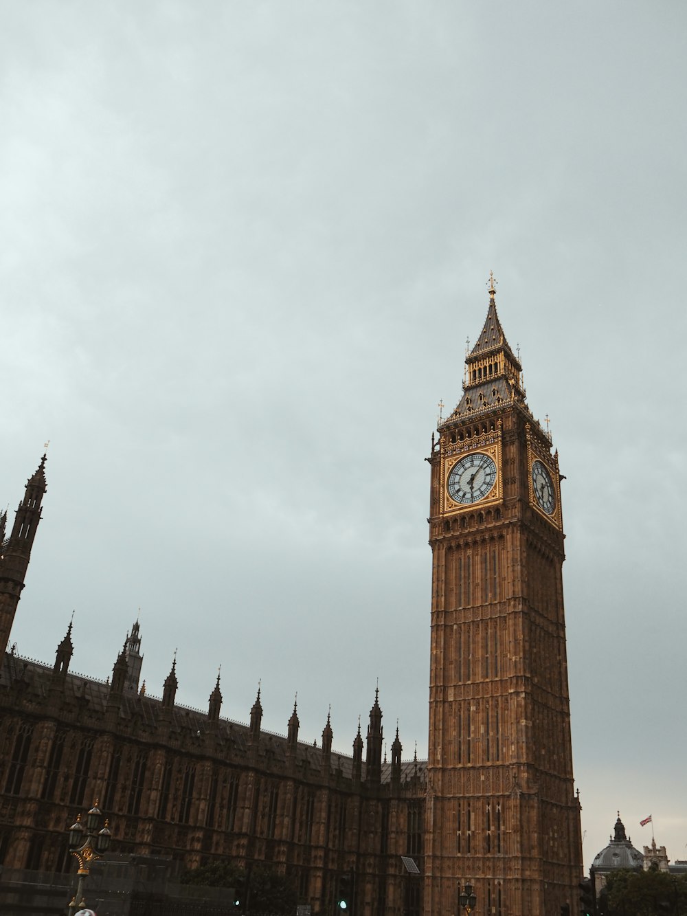 a large clock tower stands tall with Big Ben in the background