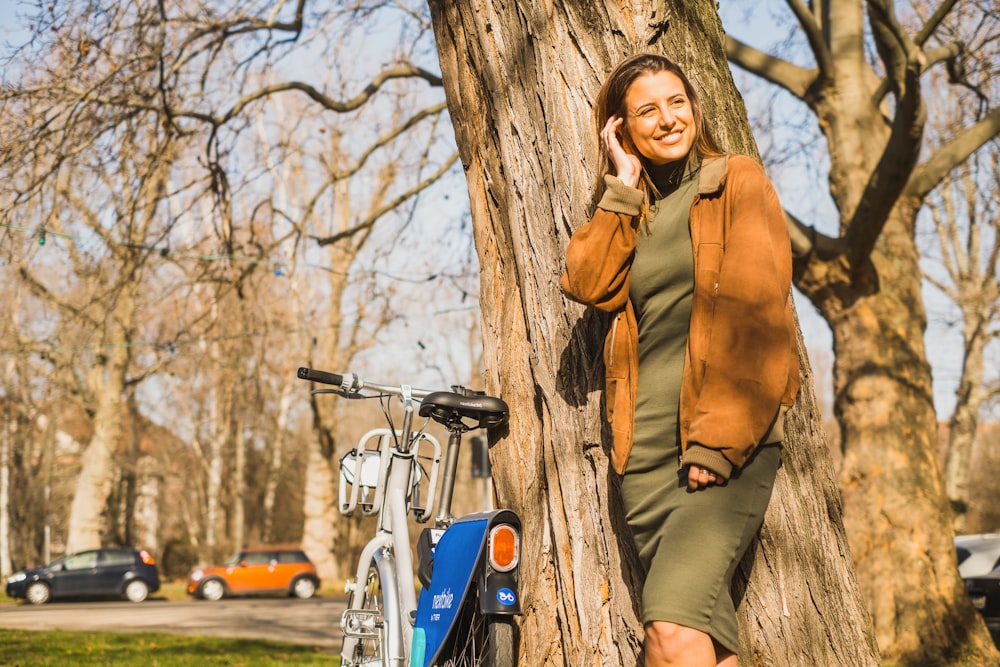 a person standing next to a tree