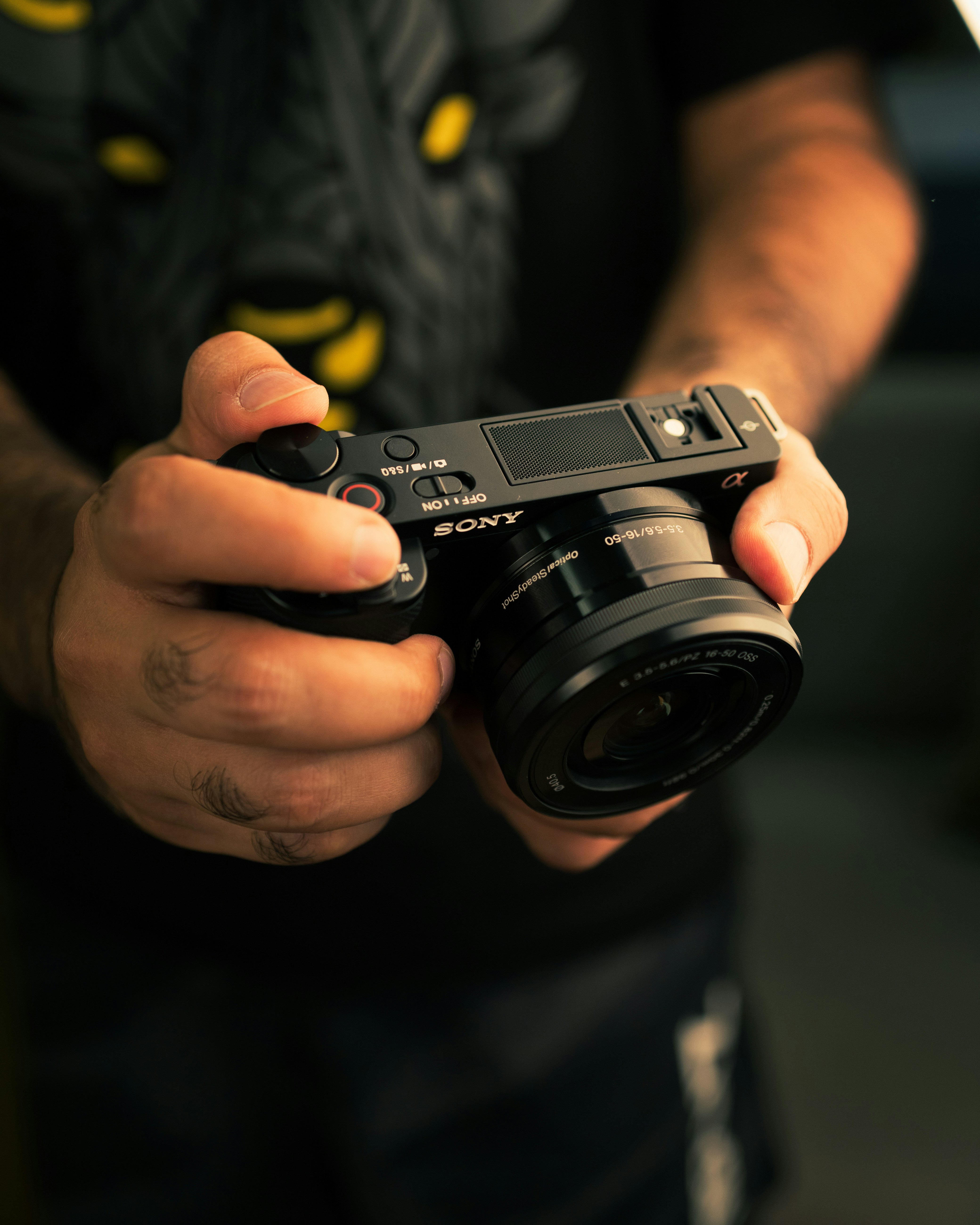 a hand holding a camera