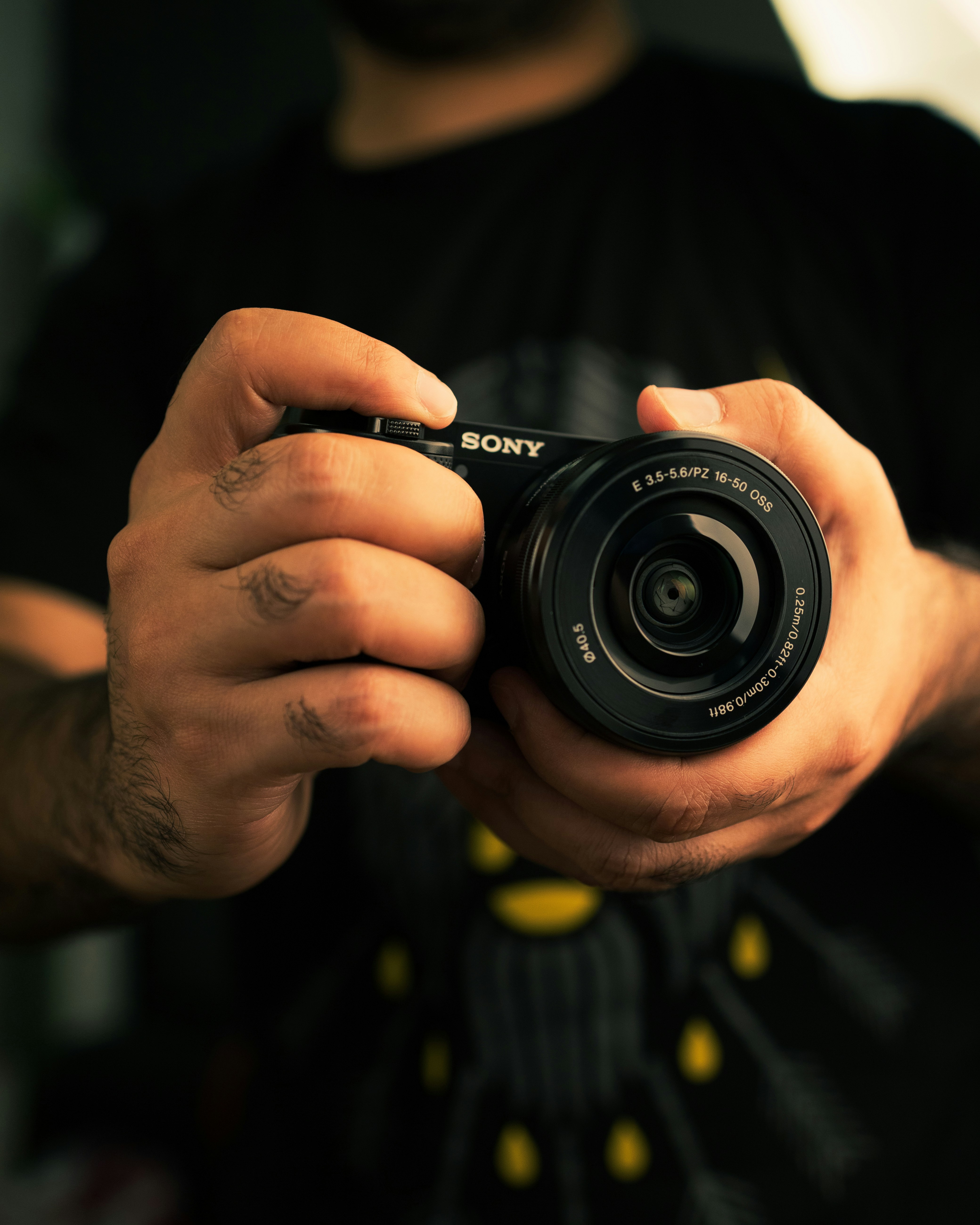 a close up of a person holding a camera