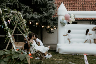 a group of people sitting on a bench in a backyard