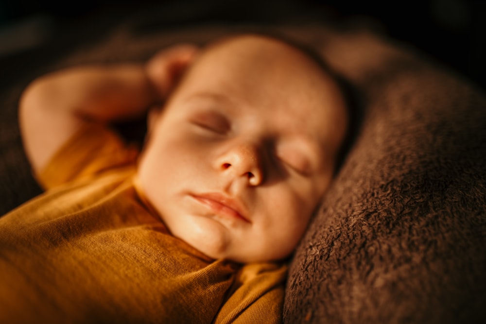 a baby sleeping on a blanket