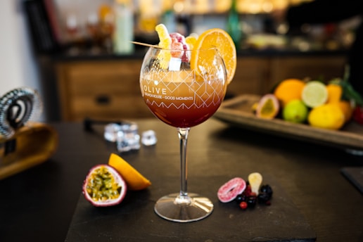 A colorful cocktail garnished with fresh fruit.