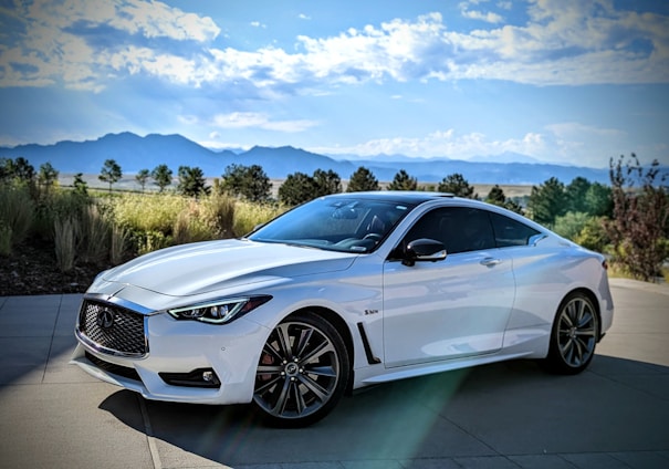 A sleek, modern car parked in a scenic location.