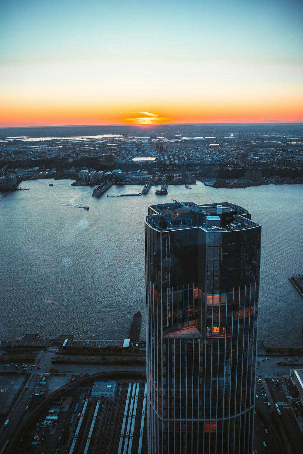 a building with a glass roof by a body of water