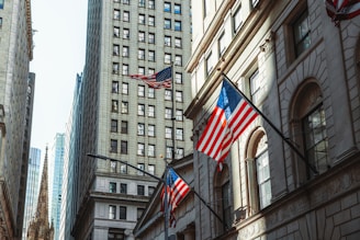a few flags flying in front of a building