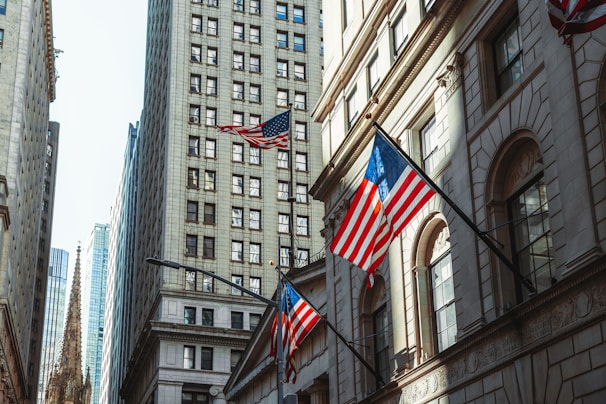 a few flags flying in front of a building