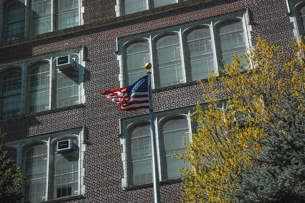 a flag on a pole in front of a building