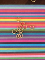 Brightly colored resin medallions laid out on a soft linen cloth.